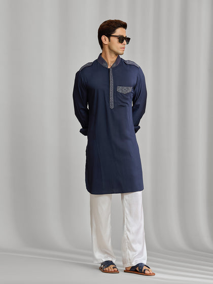 Navy blue silk kurta set with tonal embroidery, paired with white bottom.