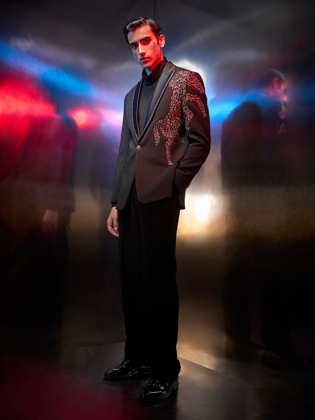 A sleek black tuxedo suit with embroidered silk texture, perfect