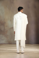 A Cream Satin Linen Sherwani with beautiful embroidery and Alighari bottoms.