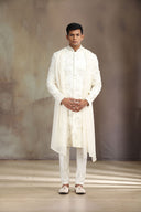 A Cream Satin Linen Sherwani with beautiful embroidery and Alighari bottoms.