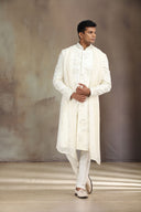 A Cream Satin Linen Sherwani with beautiful embroidery and Alighari bottoms.