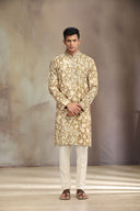 A mustard silk kurta set with a stylish blend of print and intricate embroidery.