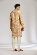 Mustard silk kurta set with refined print and intricate embroidery.