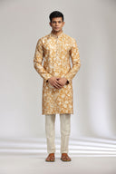 Mustard silk kurta set with refined print and intricate embroidery.