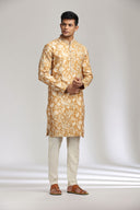 Mustard silk kurta set with refined print and intricate embroidery.