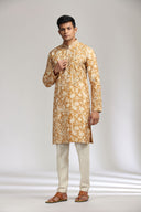 Mustard silk kurta set with refined print and intricate embroidery.