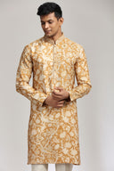 Mustard silk kurta set with refined print and intricate embroidery.