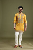 Styled festive look of yellow satin linen kurta set for men with cream aligarhi