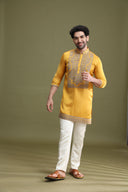 Close-up of dori embroidery on yellow satin linen kurta for men