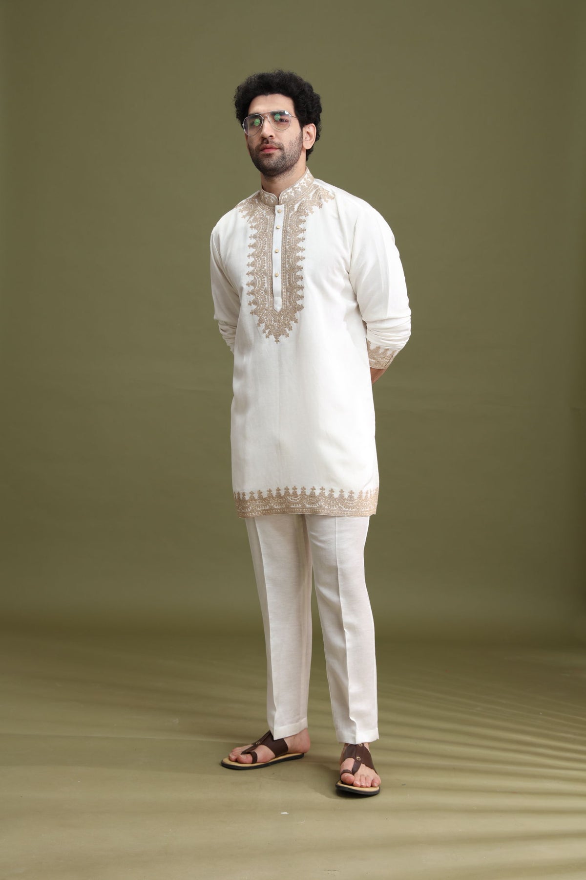 Styled festive look of white short kurta pant set for men by Kora