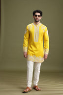 Yellow short kurta set for men with cream aligarhi and dori embroidery – front view