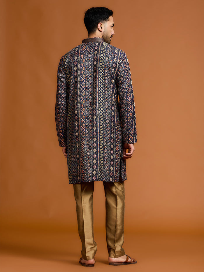Navy blue kurta with architectural print, dense tonal threadwork, and subtle shimmer, paired with antique gold Aligarh pants. - KORANM