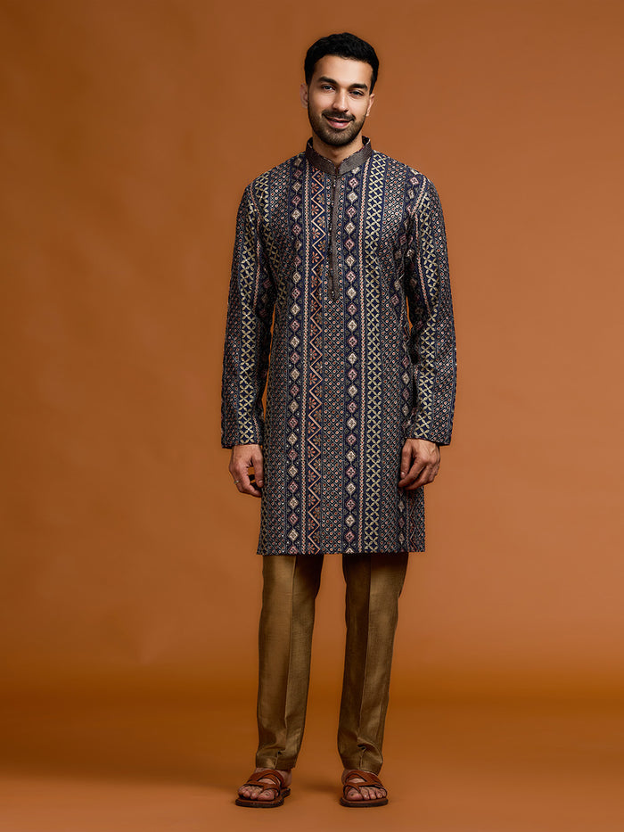 Navy blue kurta with architectural print, dense tonal threadwork, and subtle shimmer, paired with antique gold Aligarh pants. - KORANM