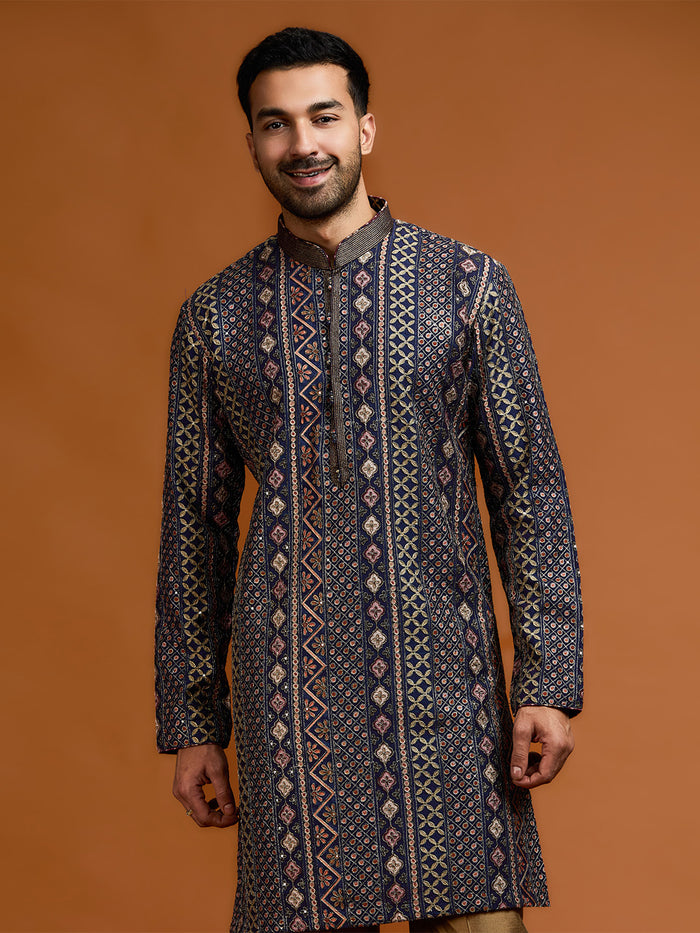 Navy blue kurta with architectural print, dense tonal threadwork, and subtle shimmer, paired with antique gold Aligarh pants. - KORANM