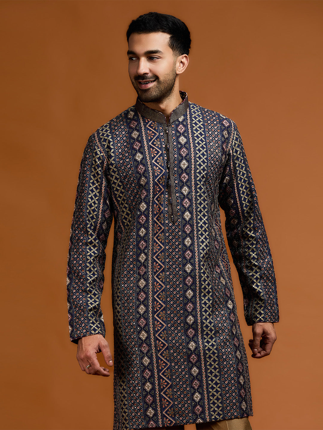 Navy blue kurta with architectural print, dense tonal threadwork, and subtle shimmer, paired with antique gold Aligarh pants. - KORANM