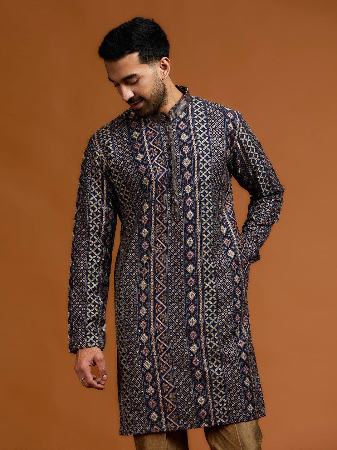 Navy blue kurta with architectural print, dense tonal threadwork, and subtle shimmer, paired with antique gold Aligarh pants. - KORANM