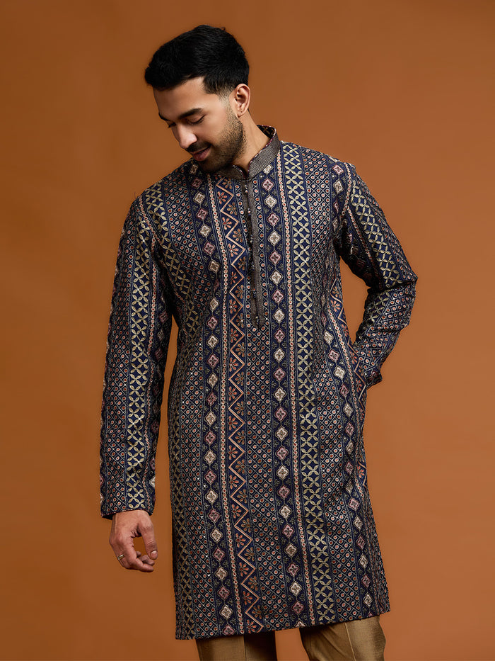 Navy blue kurta with architectural print, dense tonal threadwork, and subtle shimmer, paired with antique gold Aligarh pants. - KORANM