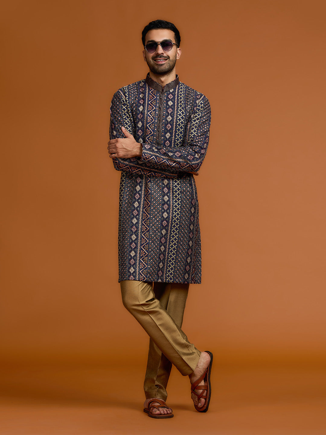 Navy blue kurta with architectural print, dense tonal threadwork, and subtle shimmer, paired with antique gold Aligarh pants. - KORANM