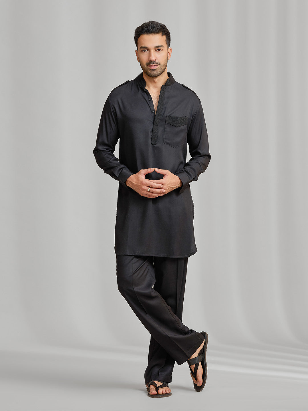 Black silk kurta set with subtle matching embroidery, paired with black bottoms. - KORANM