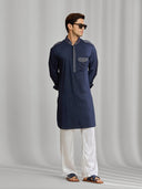Navy blue silk kurta set with tonal embroidery, paired with white bottoms. - KORANM