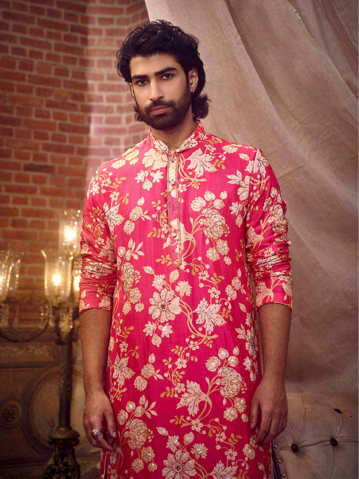 Close-up of beige button detailing and floral embroidery on pink kurta