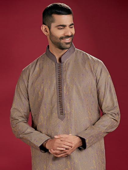 Green Jacquard Rubelli Kurta Paired with an Olive Chudidar.