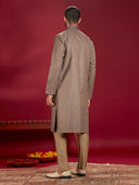 Olive Jacquard Rubelli Kurta Paired with an Olive Chudidar.