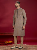 Olive Jacquard Rubelli Kurta Paired with an Olive Chudidar.