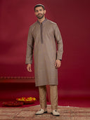 Olive Jacquard Rubelli Kurta Paired with an Olive Chudidar.