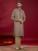Olive Jacquard Rubelli Kurta Paired with an Olive Chudidar.