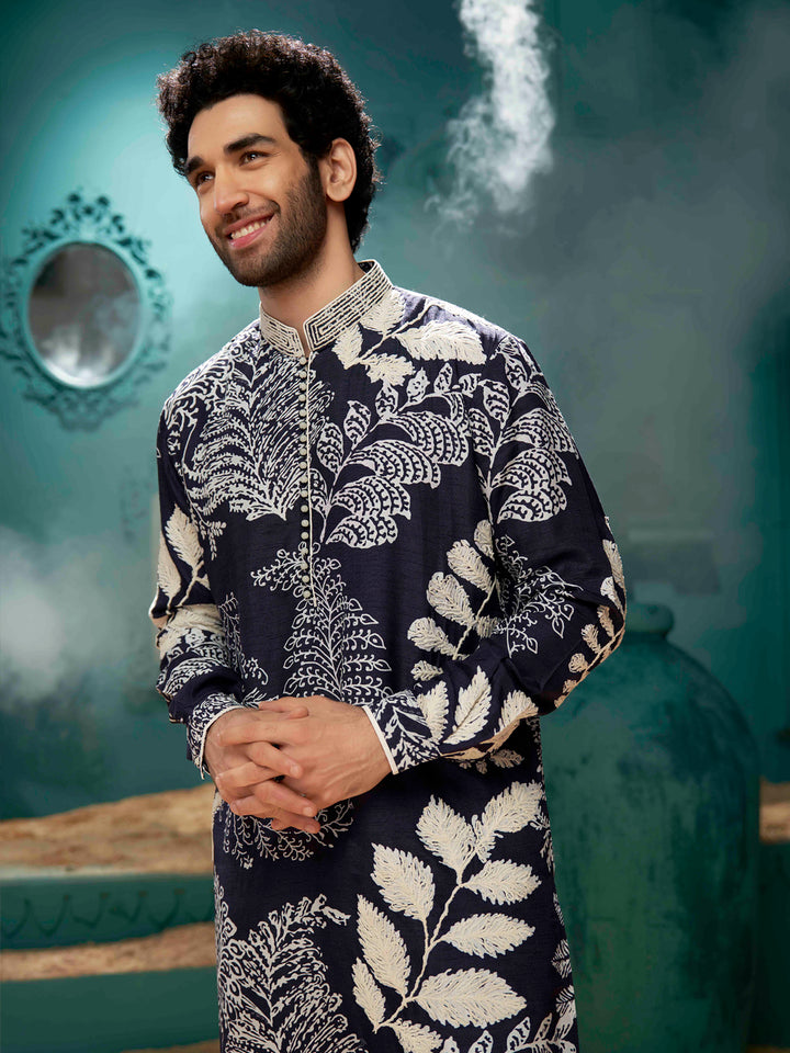 A navy blue kurta with cream color aligadi