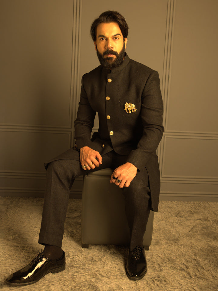 Elegant Black Matka Silk Nawabi with Elephant Brooch Paired with a Black Aligadi Pant.
