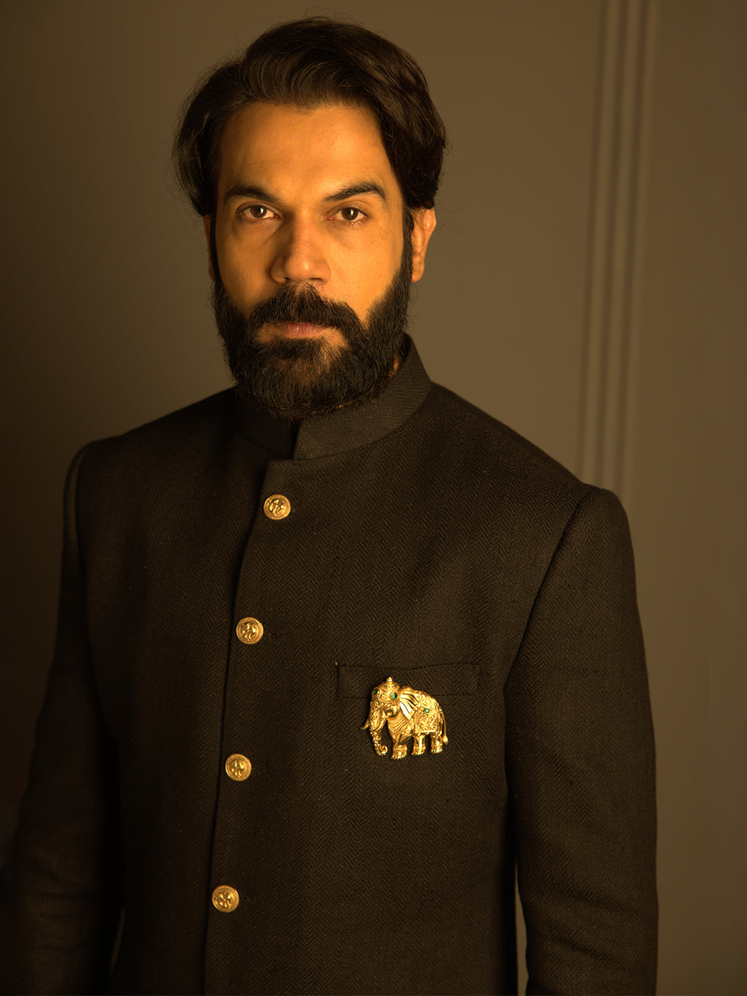 Elegant Black Matka Silk Nawabi with Elephant Brooch Paired with a Black Aligadi Pant.