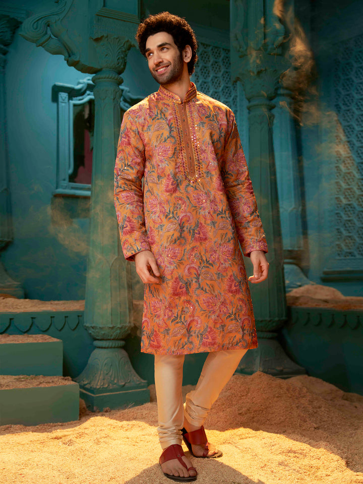 Orange kurta made with blended silk with a natural Chudidar pant.