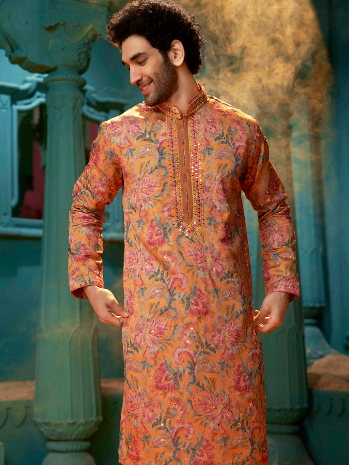 Orange kurta made with blended silk with a natural Chudidar pant.