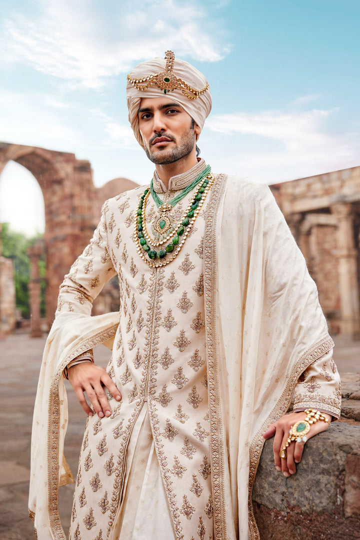 Beige Embroidered Sherwani with Anarkali Silk Kurta and Beige Churidaar for Groom.