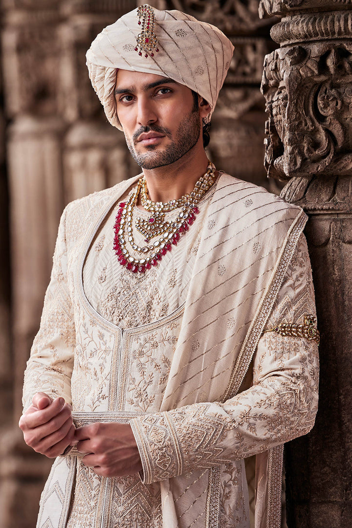 Cream Embroidered Sherwani with Anarkali Silk Kurta and Cream Churidaar.