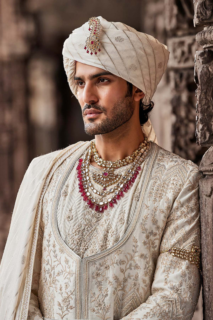 Cream Embroidered Sherwani with Anarkali Silk Kurta and Cream Churidaar.