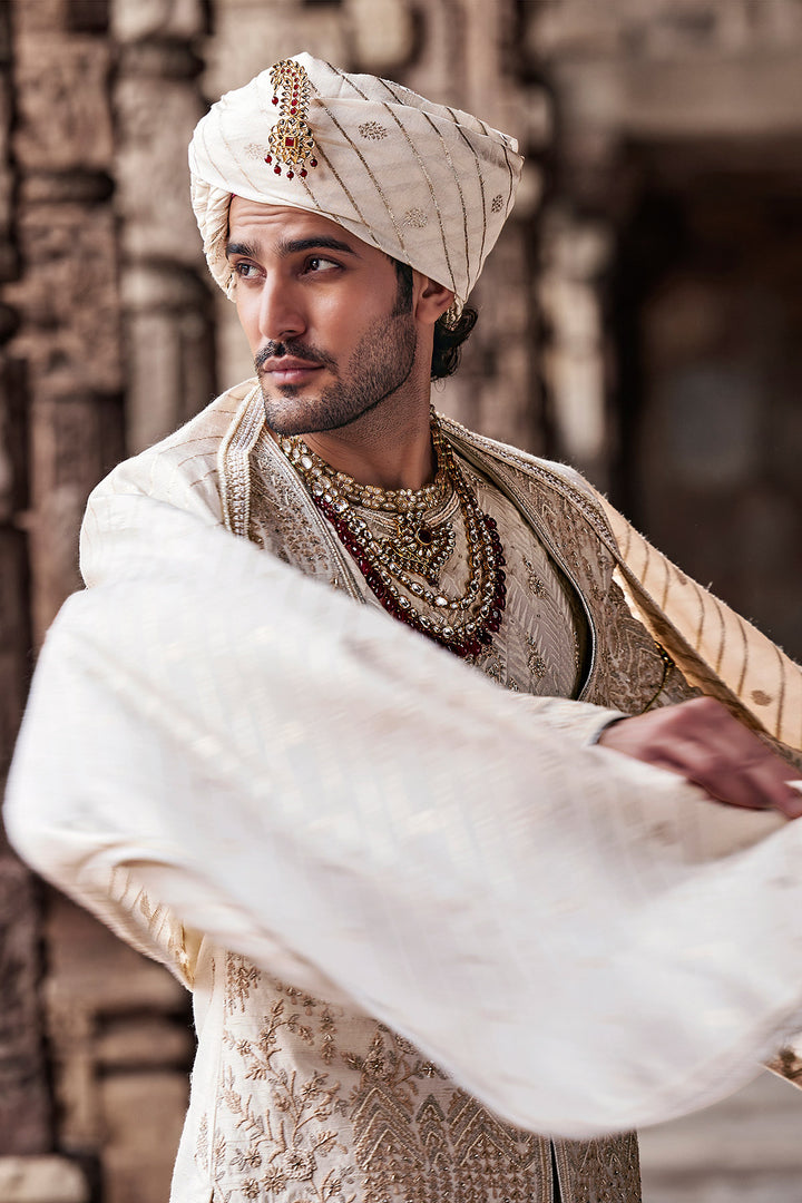 Cream Embroidered Sherwani with Anarkali Silk Kurta and Cream Churidaar.