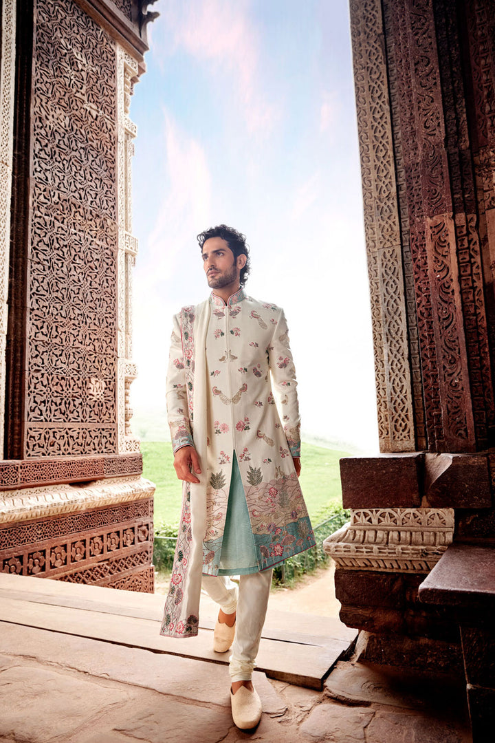 Cream Tesla Fabric Sherwani with Matching Kurta, Dupatta, and Churidaar.