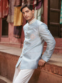 Men wearing aqua Bandhgala Jodhpuri suit styled with white pant
