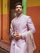 Men wearing baby pink Zari Butti sherwani with matching stole and white churidar