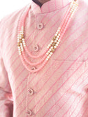 Close-up of Hil silk fabric texture on pink sherwani for men