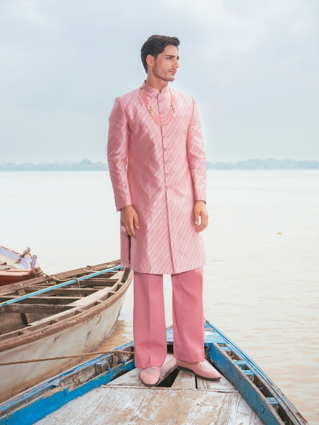 Men wearing pink Hil silk sherwani set with matching Aligarhi bottom